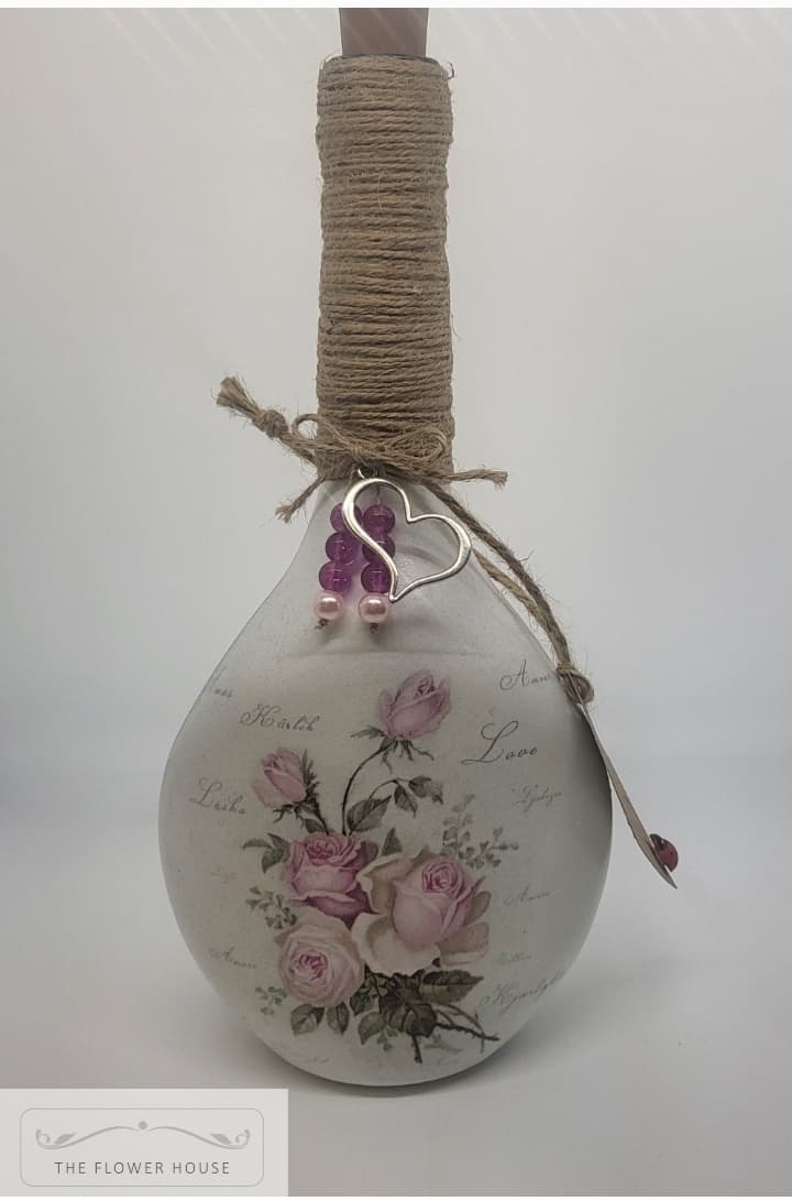 Decoupaged Light Up Bottle With A Variety Of Different Designs