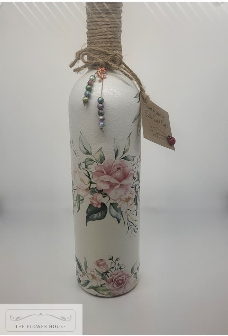Decoupaged Light Up Bottle With A Variety Of Different Designs