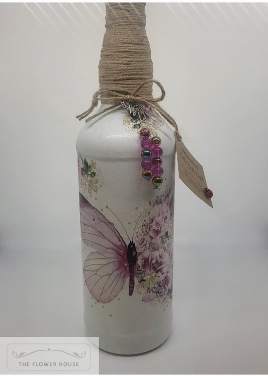 Decoupaged Light Up Bottle With A Variety Of Different Designs