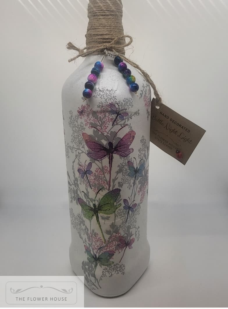 Decoupaged Light Up Bottle With A Variety Of Different Designs